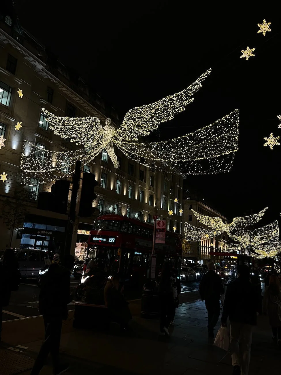 busy people walking on regent street during night time
