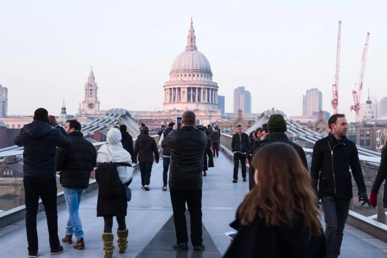 people walking on concrete walkway near dome