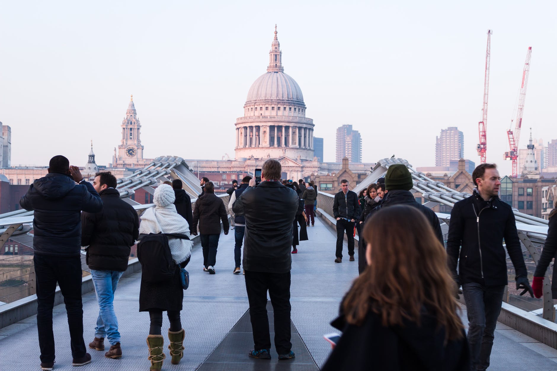 people walking on concrete walkway near dome